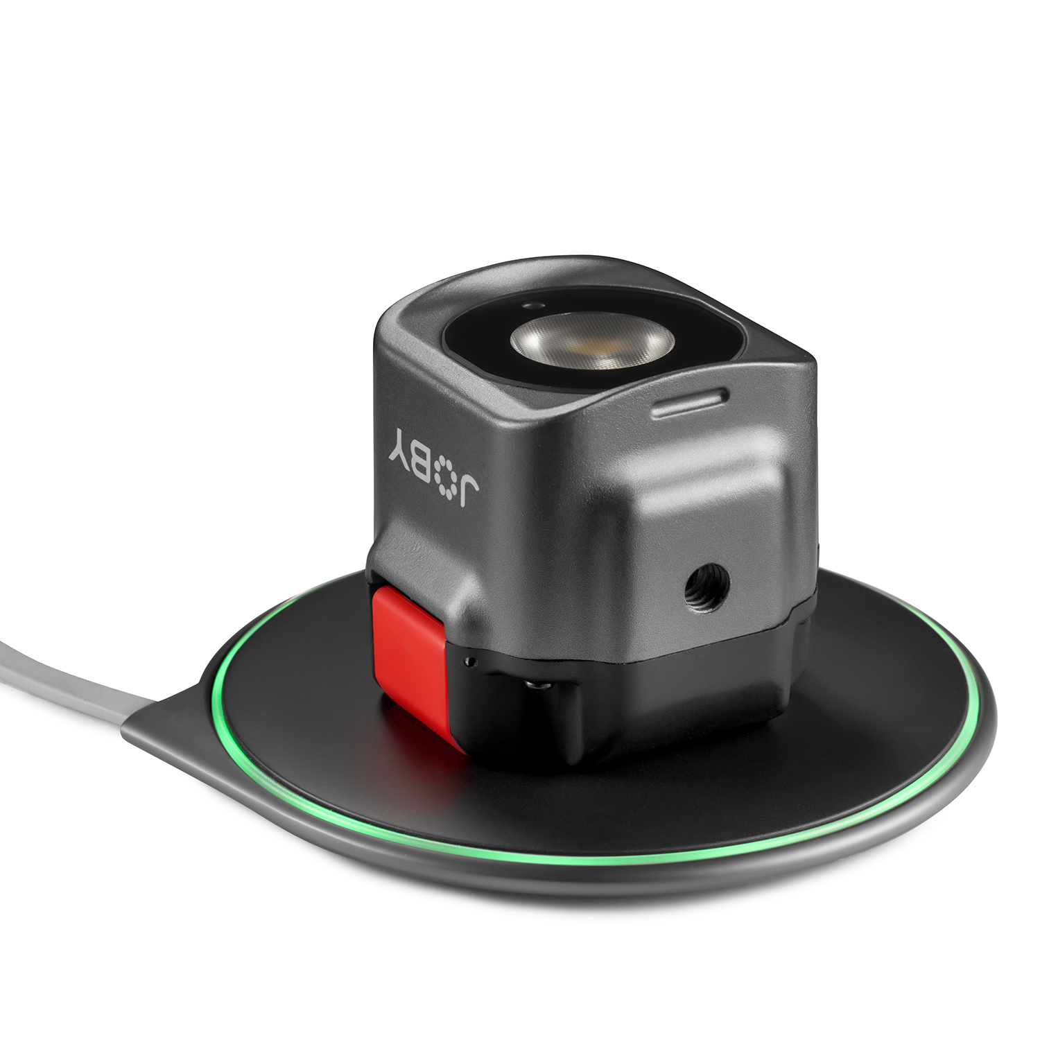 Black and gray device on a charging pad with a red button and green light.