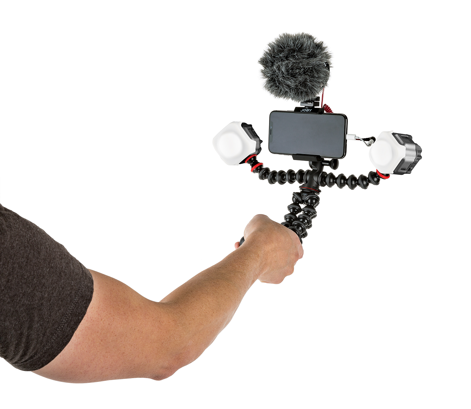 Person holding a phone on a flexible tripod with lights and a microphone. White background.