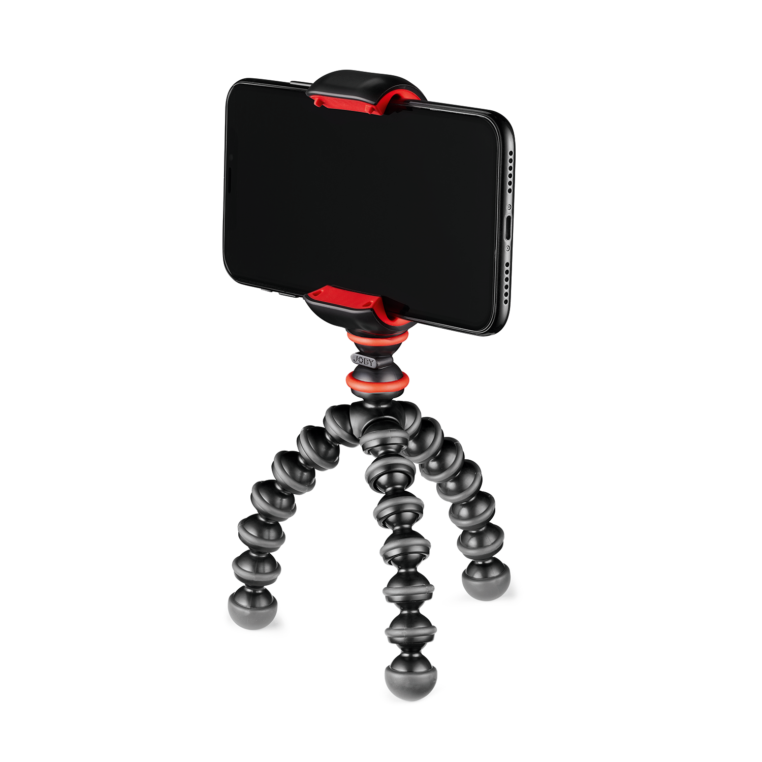A black smartphone is attached to a flexible black and red tripod, on a white surface.