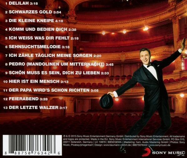 CD-Cover mit einem Mann im Anzug, Text auf der Rückseite, in einem Theater.