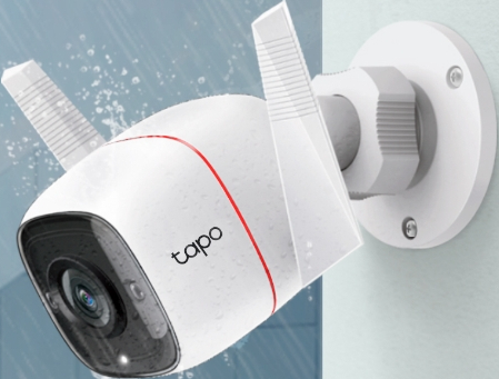 White security camera mounted on a wall. It has two antennas and a red accent line.