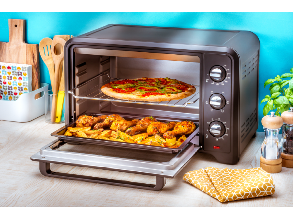 Un horno con pizza y pollo con patatas.