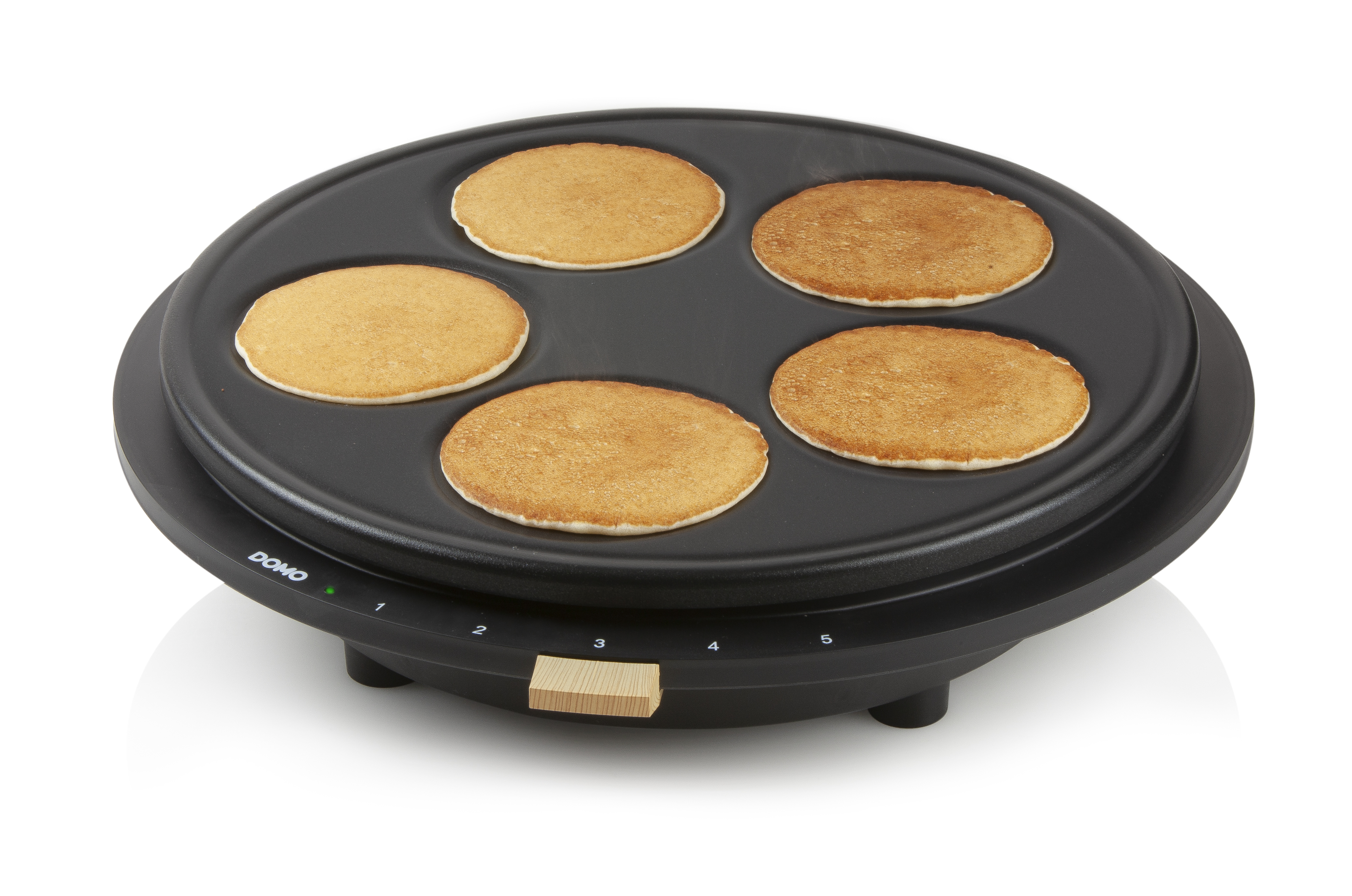 Black pancake maker with five pancakes on it. The numbers 1-5 are on the side.