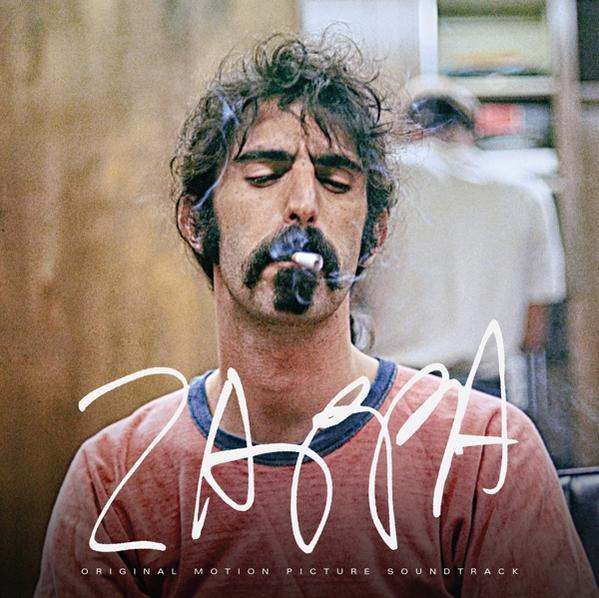 Zappa albumhoes. Een man rookt, draagt een rood shirt en heeft een snor.