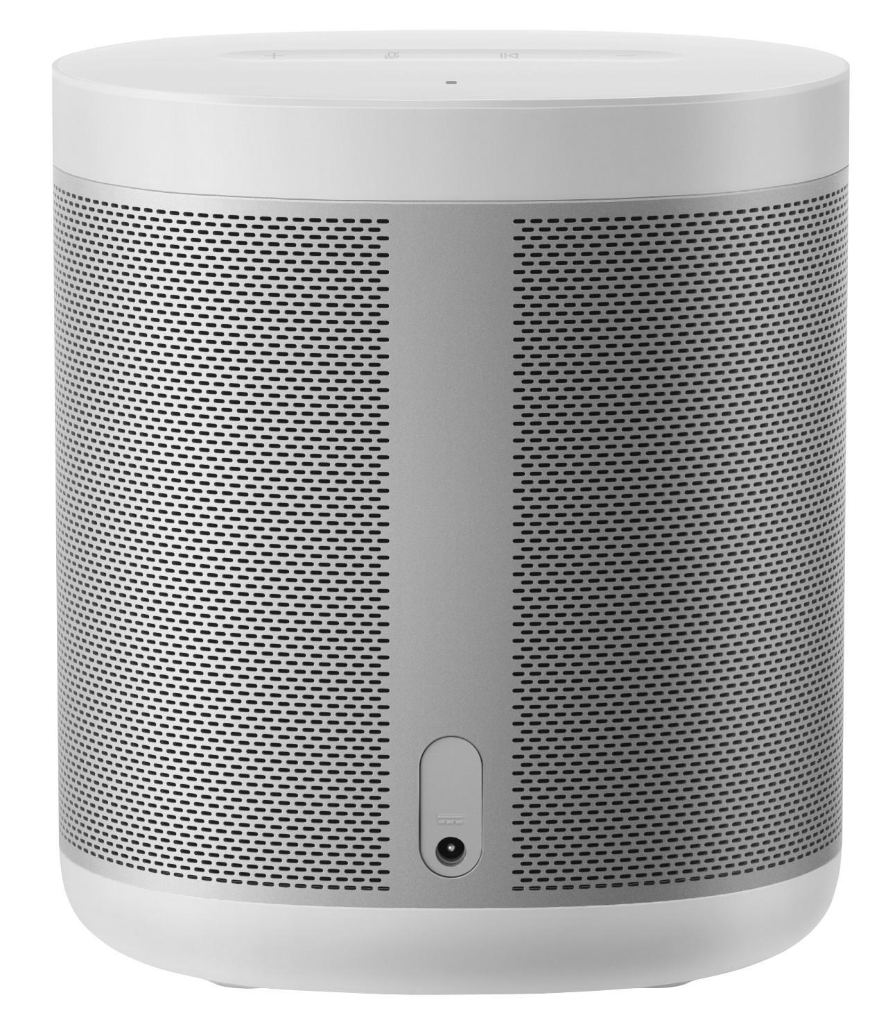 Ein zylindrischer, silberner und weißer Lautsprecher. Er hat viele kleine Löcher auf dem silbernen Teil.