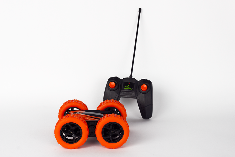 Toy remote control car with orange wheels and a black remote.