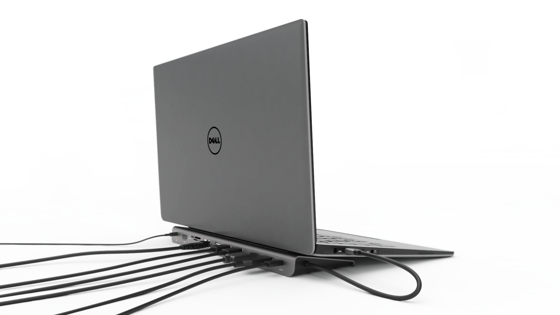 Ein silberner Laptop, der mit einer Dockingstation verbunden ist, mit mehreren Kabeln, die sich nach links erstrecken.