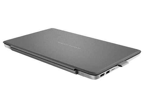 Ein geschlossener grauer Laptop auf einer weißen Oberfläche, seitlich mit Anschlüssen.