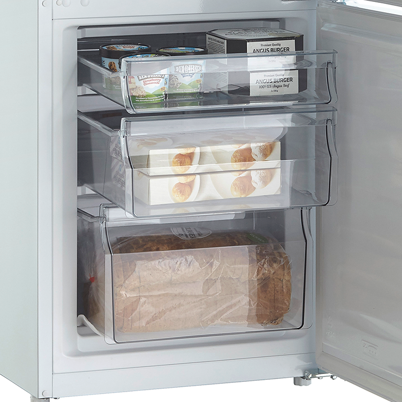 Open freezer with three clear drawers, filled with frozen food items like burgers and bread.