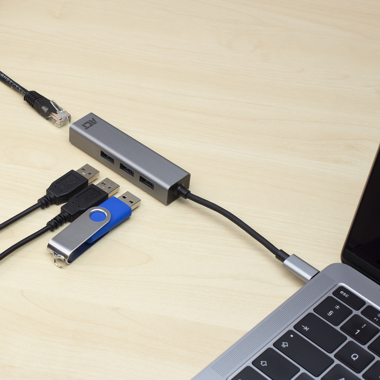 A USB hub with several cables connected to a laptop.