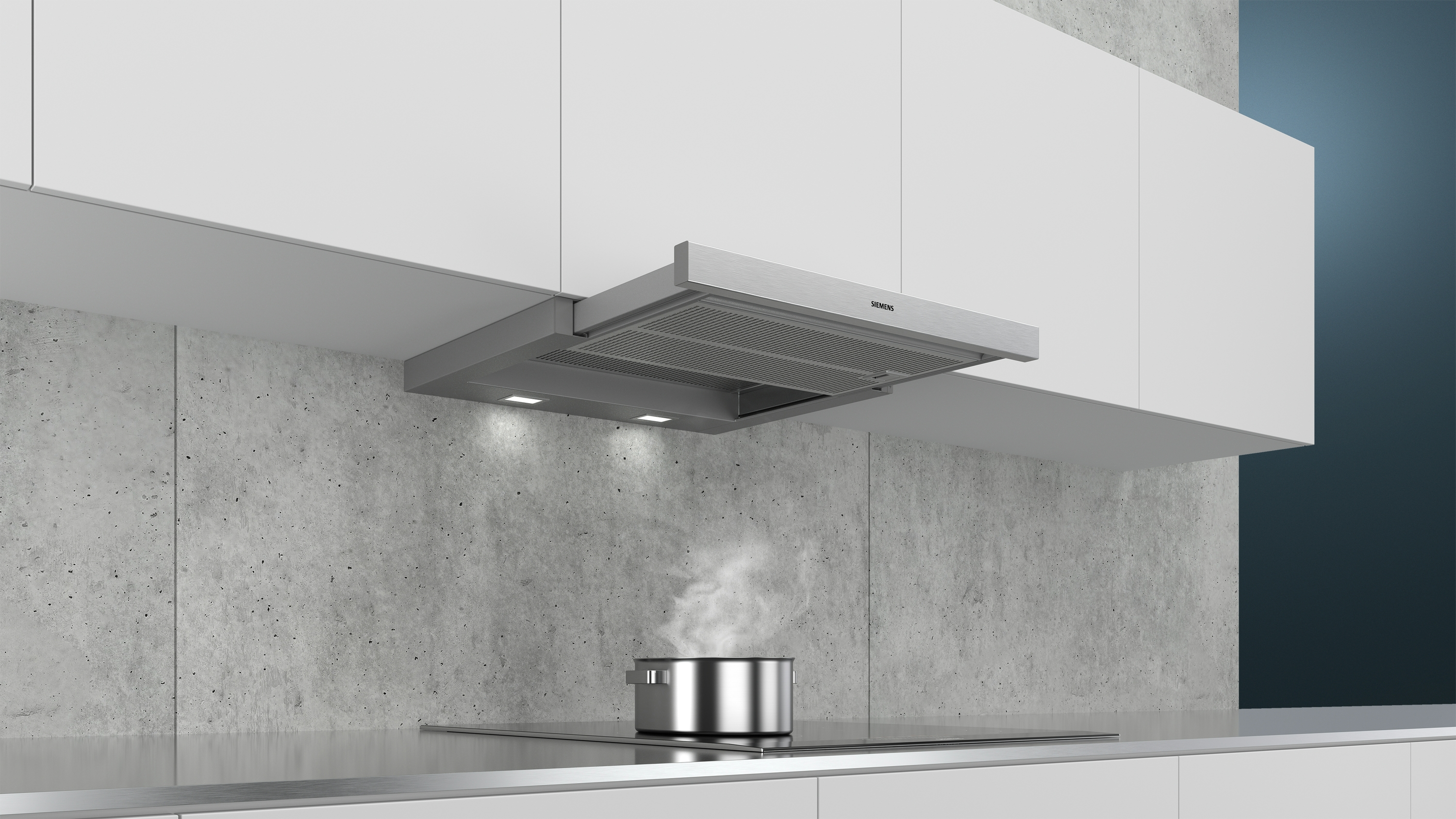 Kitchen with a silver range hood above a pot on a stove, with steam rising.