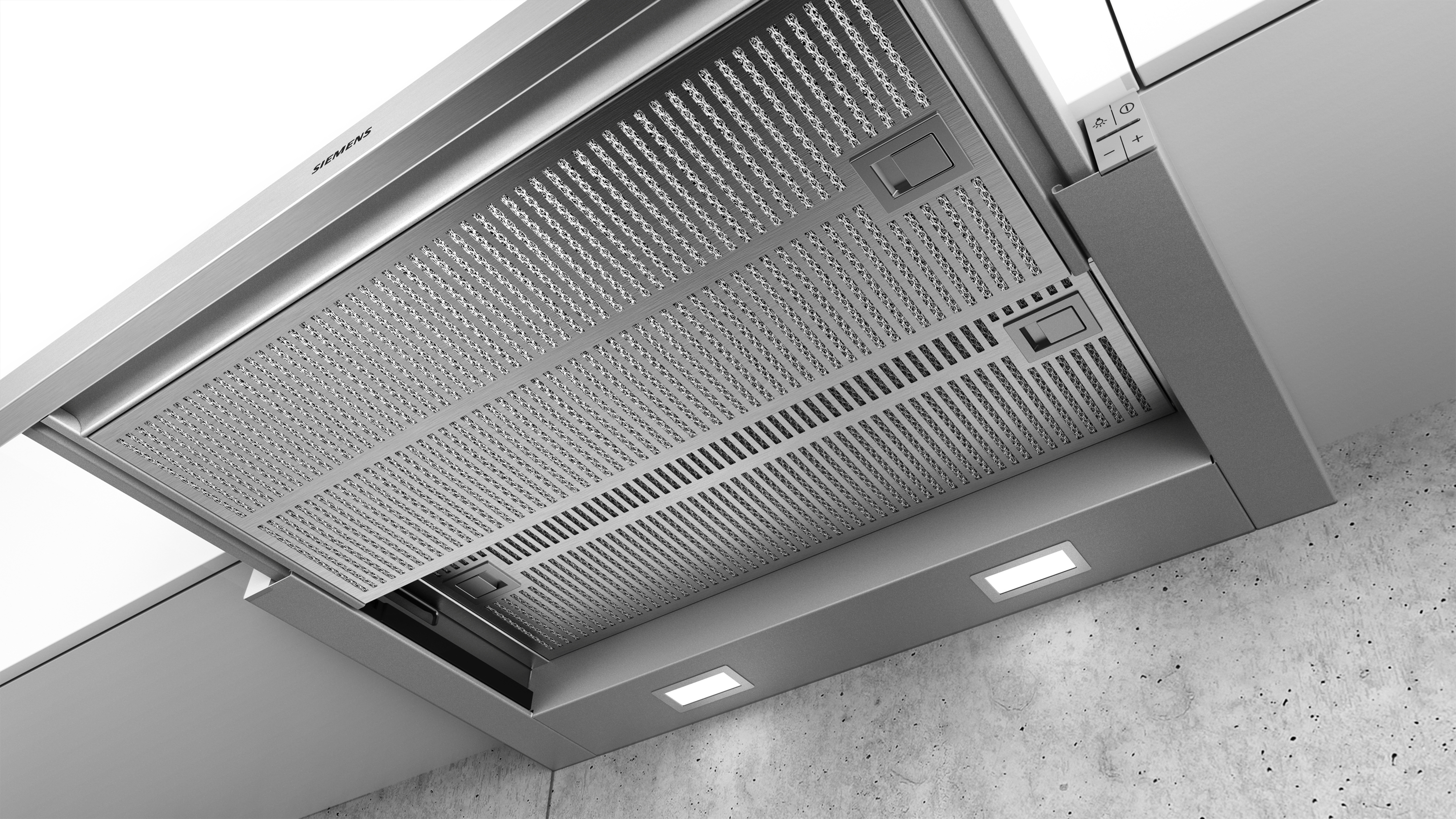 Una campana extractora de cocina se muestra desde abajo, con luces y una superficie de acero inoxidable.