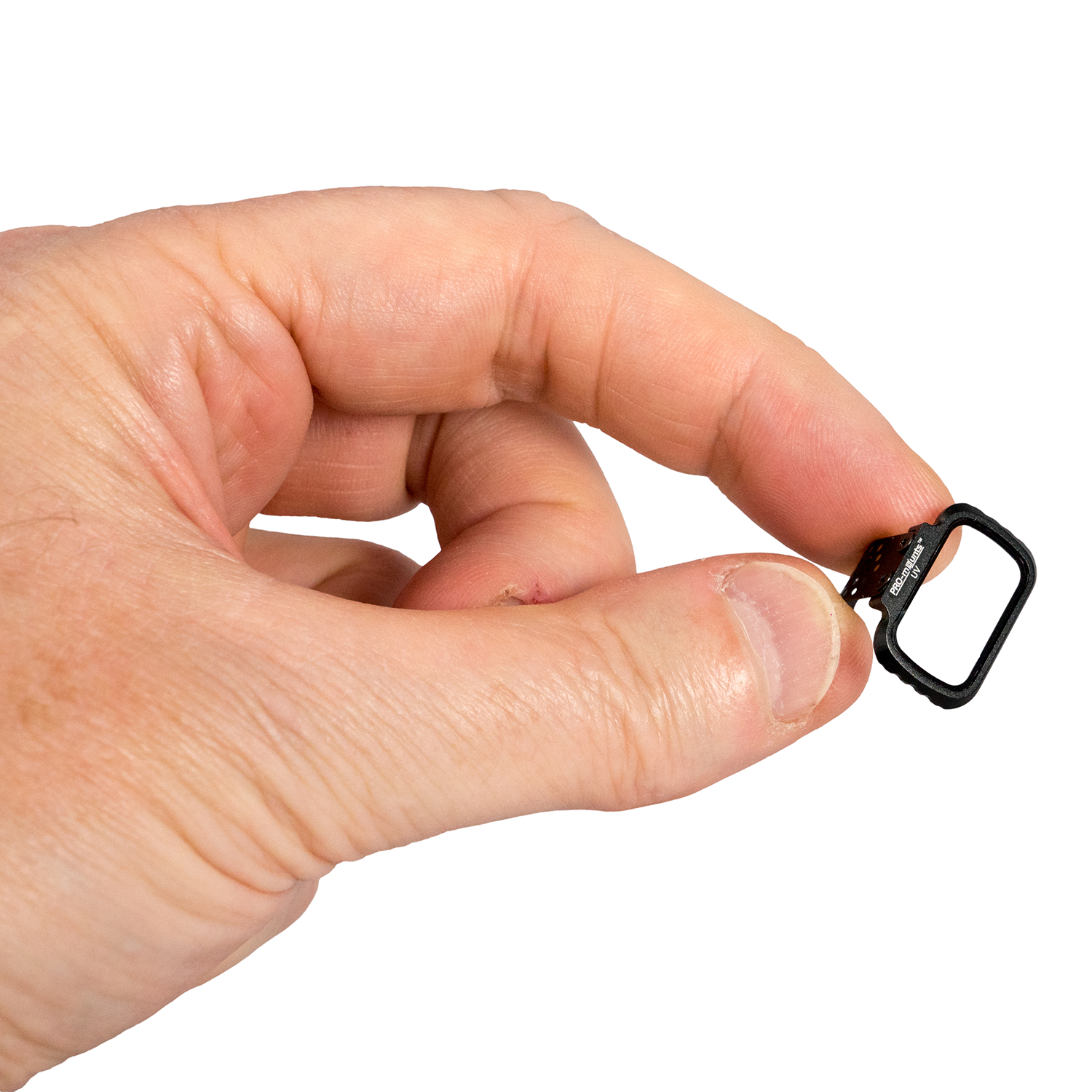 A hand holding a black lens ring with a square opening.