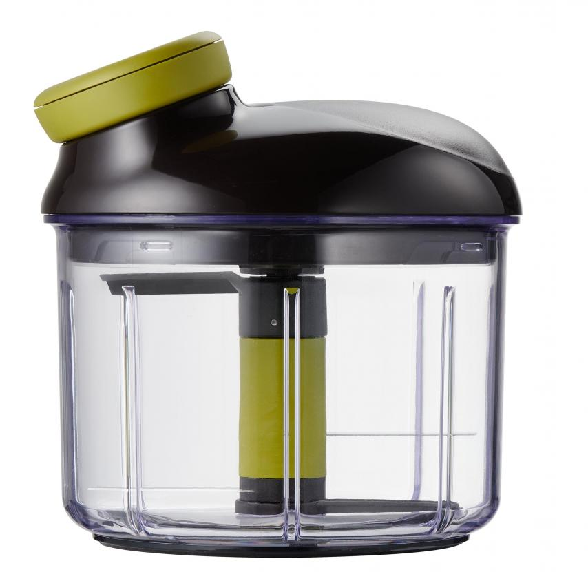 Food chopper with transparent container and green top.
