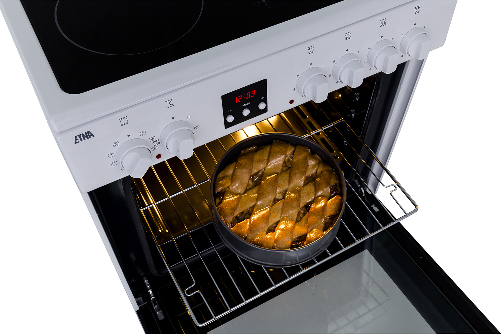 An oven with a pie inside. The oven door is open. Knobs and display are visible.
