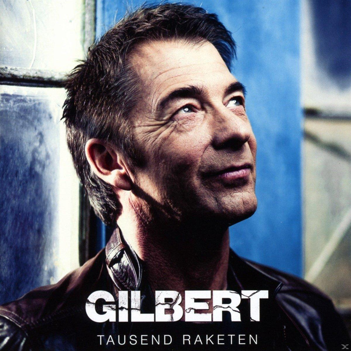 Ein Mann mit dunklem Haar blickt nach oben mit dem Text 'Gilbert' und 'Tausend Raketen' darunter.