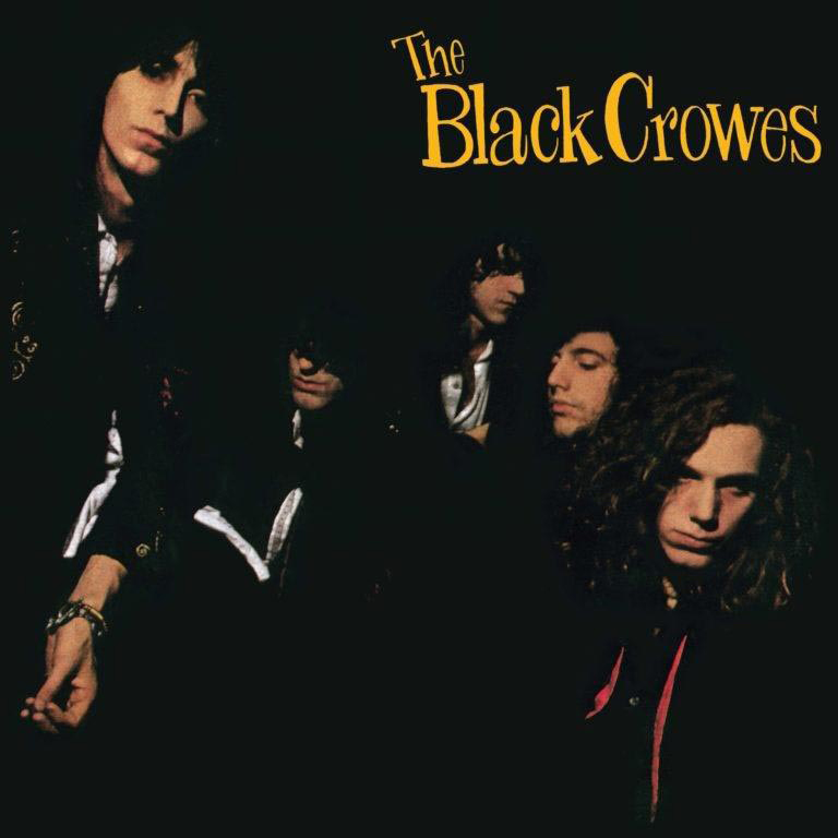 Albumcover mit einer Band von vier Männern in dunkler Kleidung auf schwarzem Hintergrund. Titel: The Black Crowes.