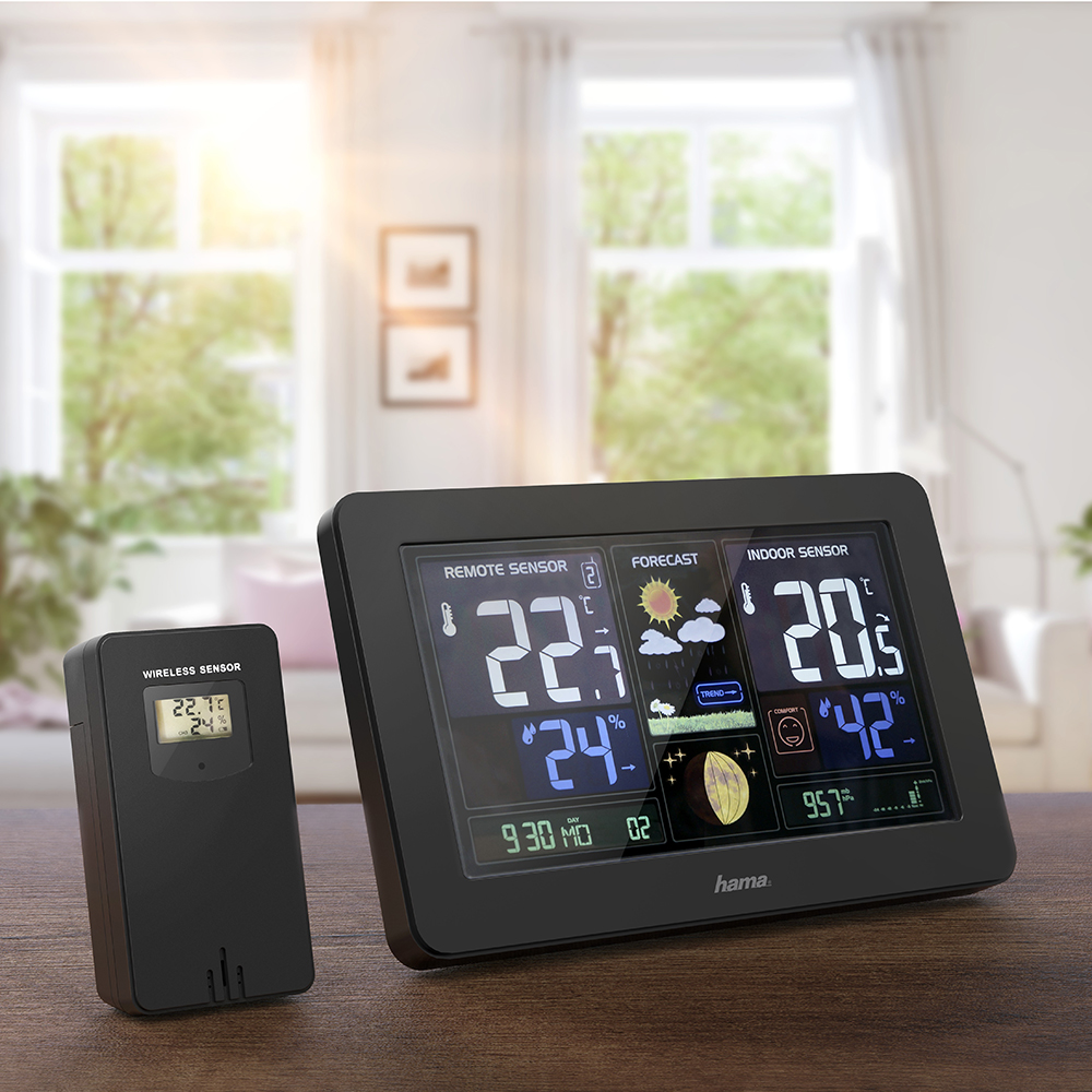 Weather station with a black display showing indoor/outdoor temp, forecast. A wireless sensor is on the left.