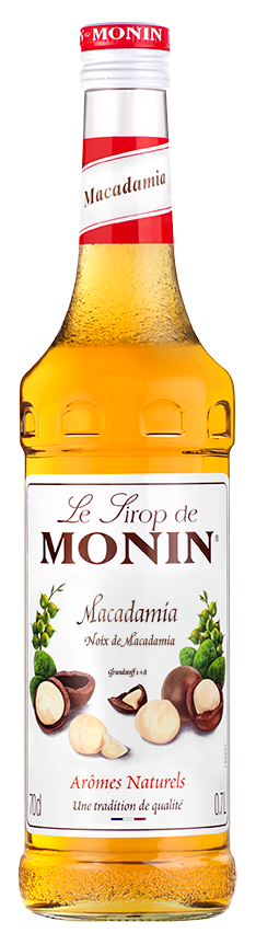 Monin Macadamia Sirup Flasche mit Nüssen.