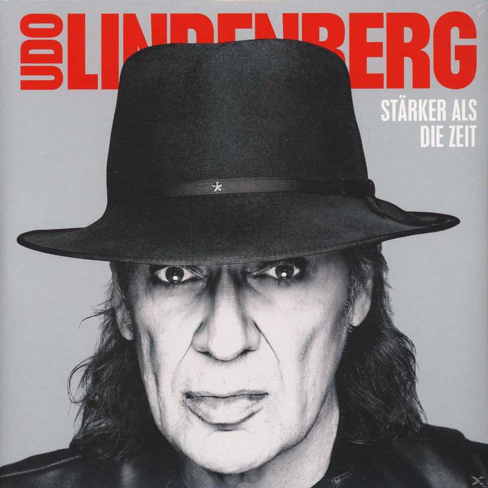 Albumcover mit Udo Lindenberg mit schwarzem Hut, Nahaufnahme. Grauer Hintergrund.