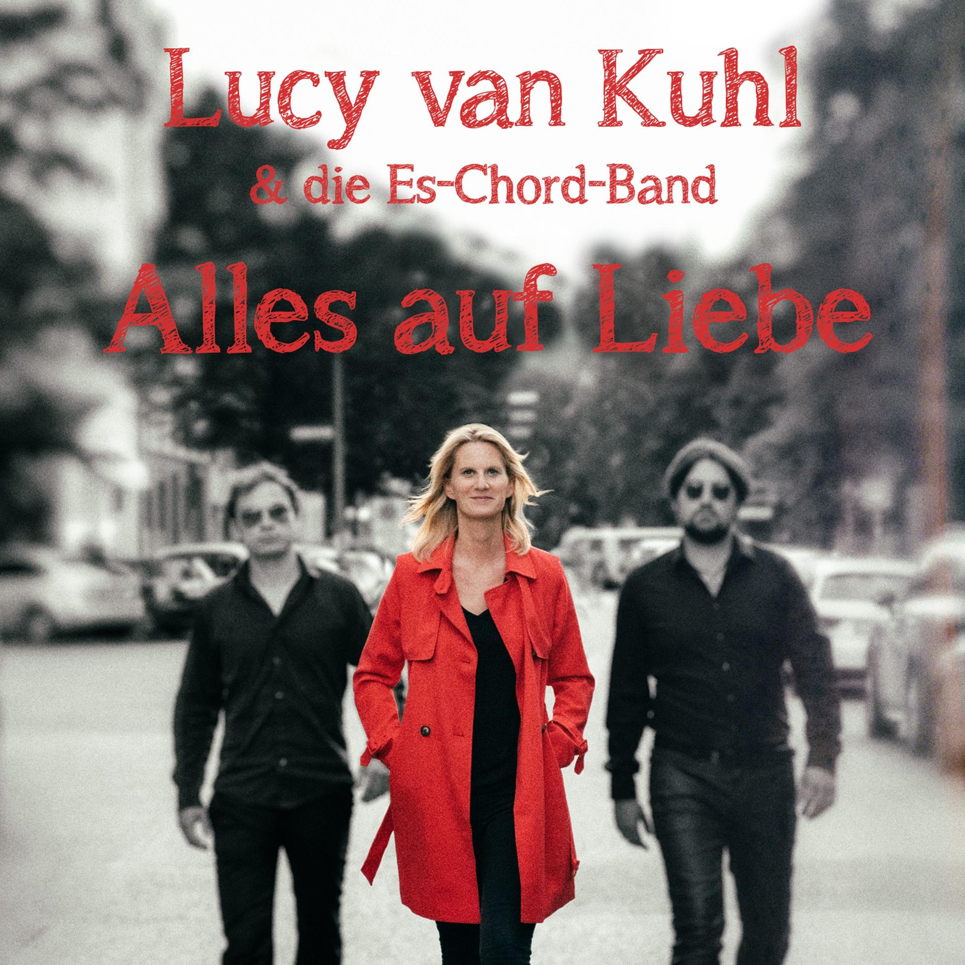 Albumcover: Lucy van Kuhl und Band, drei Personen gehen auf einer Straße. Titel: Alles auf Liebe in Rot.