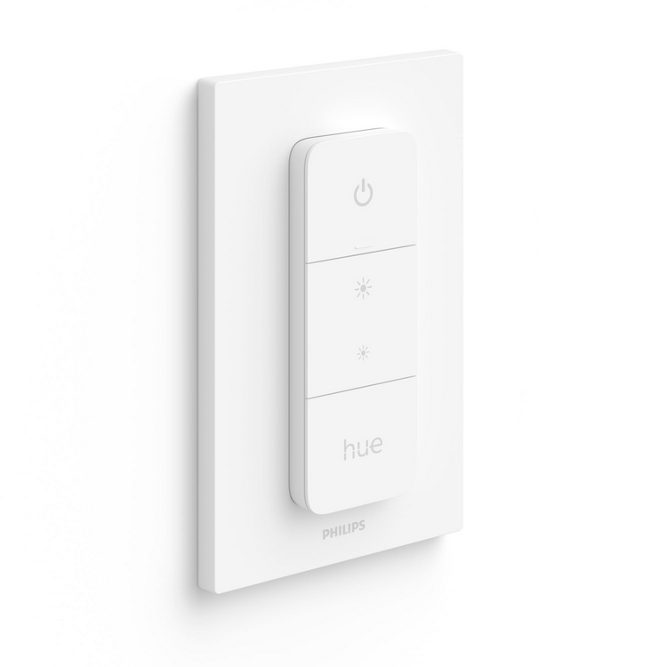 Un interruptor inteligente Philips Hue blanco en una pared blanca. Tres botones y el logotipo Hue son visibles.