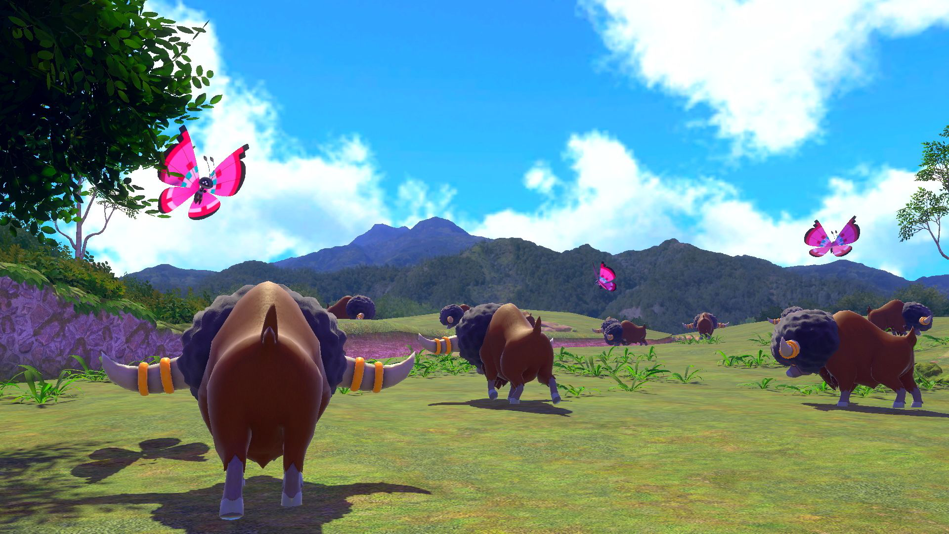 Landschaft mit Bisons und Schmetterlingen. Grünes Feld, Berge, blauer Himmel. Cartoon-Stil.