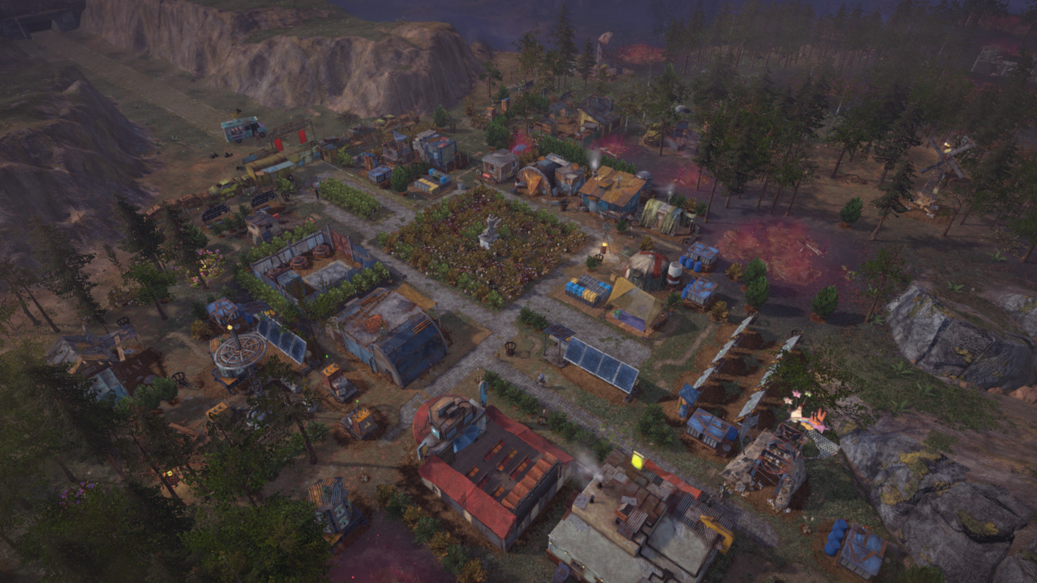 An aerial view of a settlement with buildings and farmland. The overall color is muted.