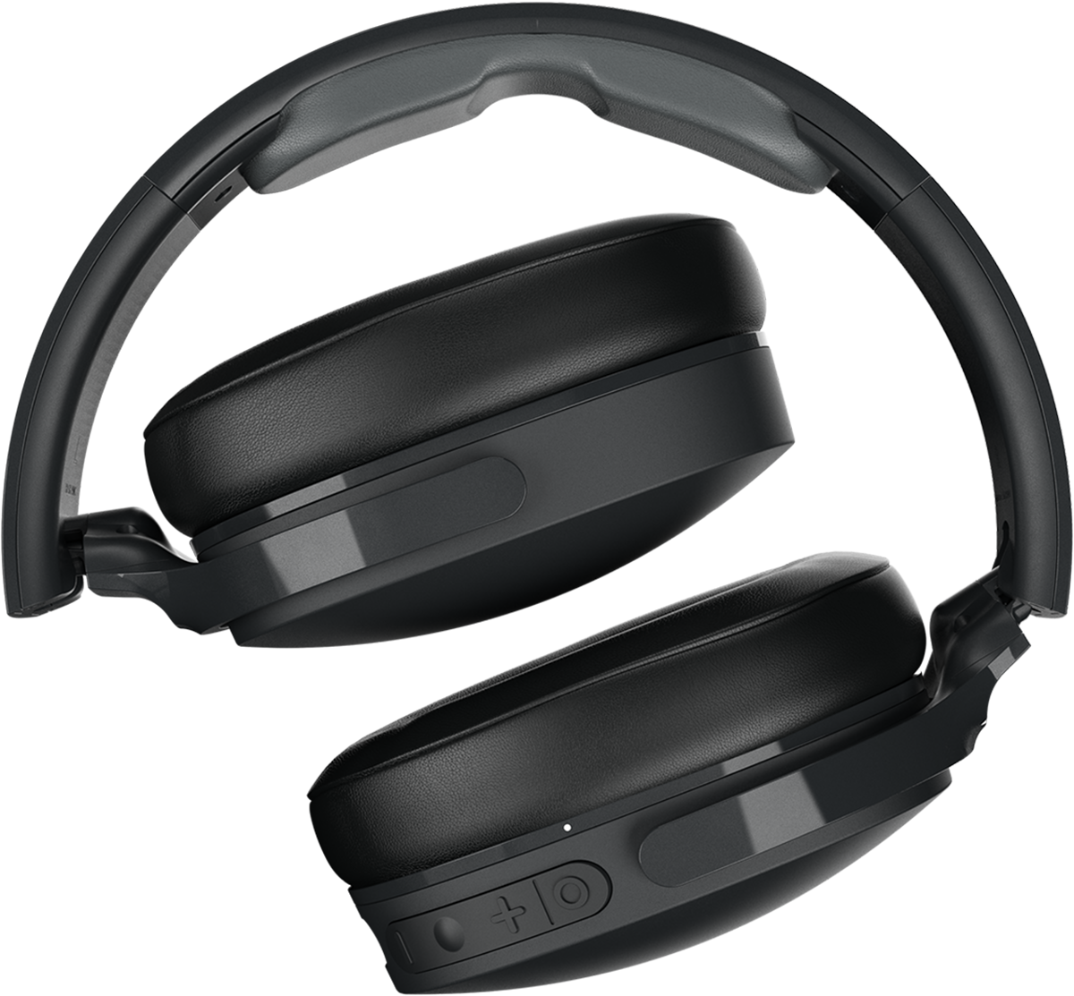 Black headphones, folded, on a black background. Buttons and a charging port are visible.
