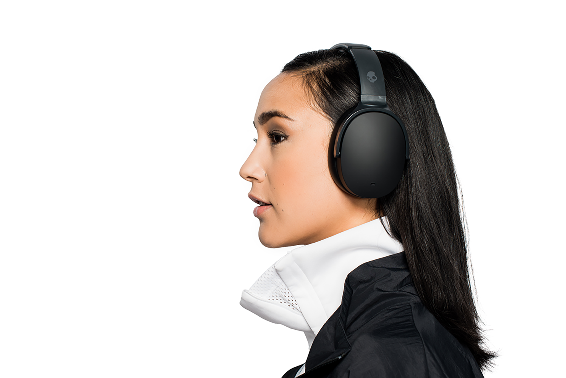 Woman in profile wearing black headphones, white background.