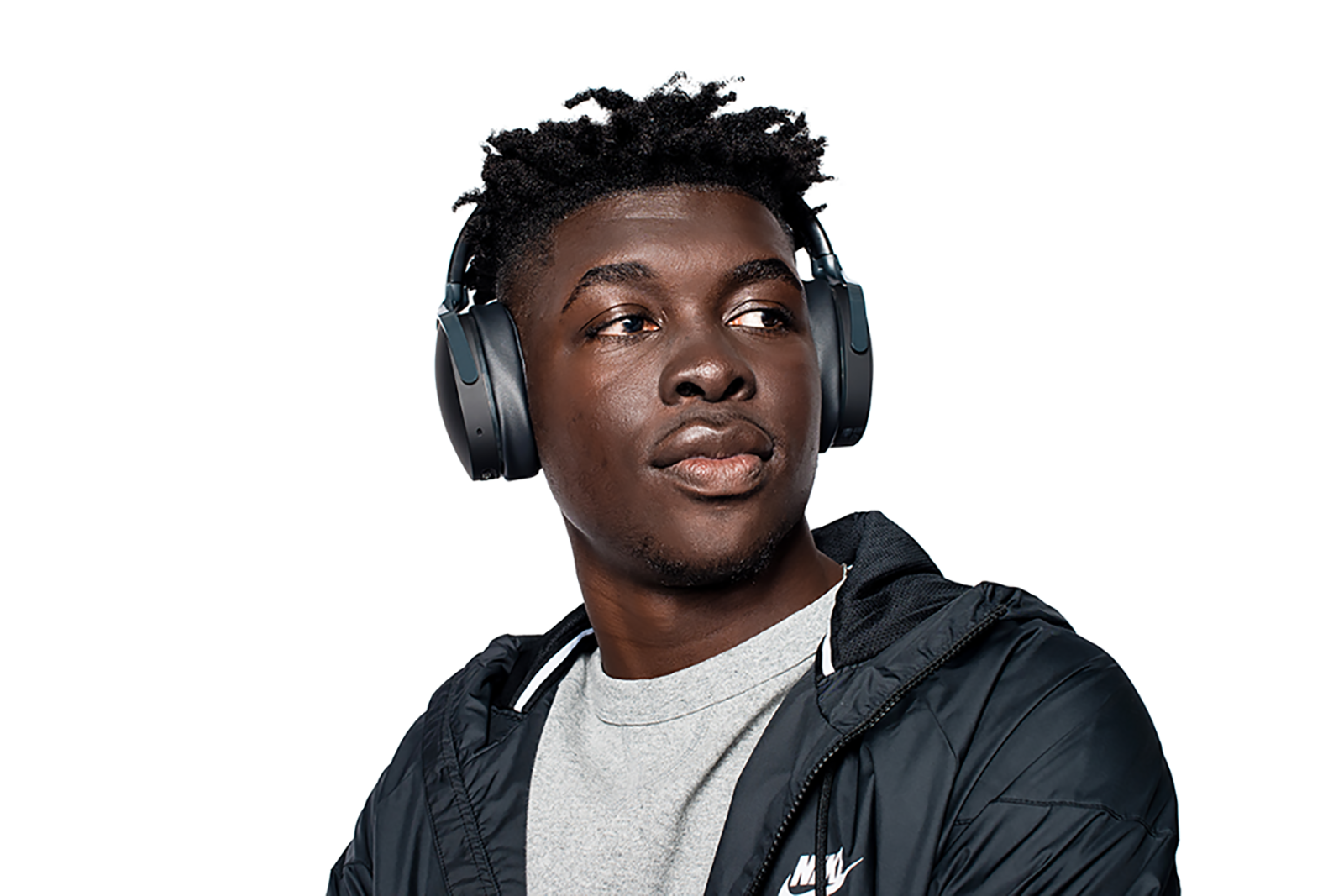 Young black man wearing headphones and black jacket looking right.