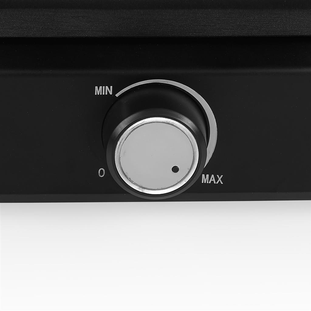 Gros plan d'un bouton noir avec des marquages min et max sur une surface noire.