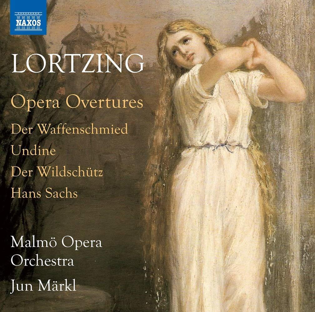 Albumcover mit einer Frau in weißem Kleid an einem Wasserfall. Text oben und unten.