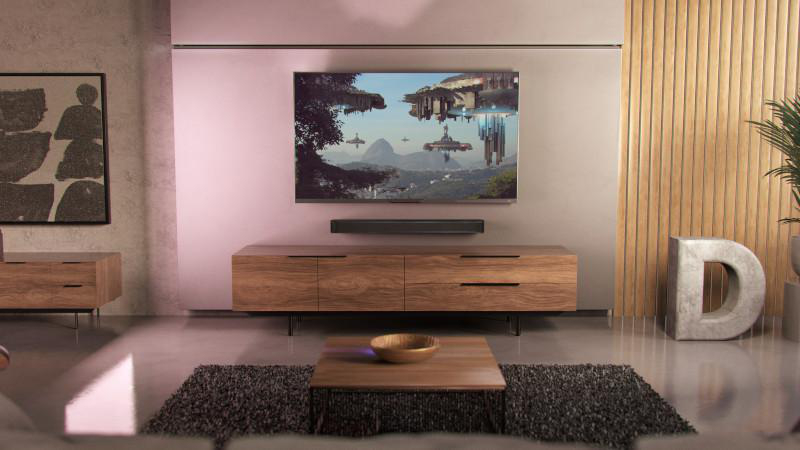 Ein Wohnzimmer mit Fernseher, Soundbar, Holzschrank und Couchtisch mit einer Schüssel.