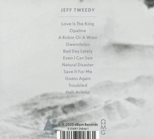 L'arrière d'un boîtier de CD avec des titres de chansons et des logos, sur fond clair.