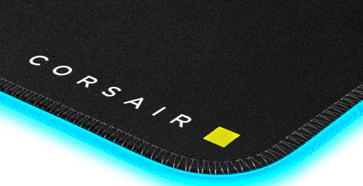 Tapis de souris noir avec texte Corsair blanc et un carré jaune.