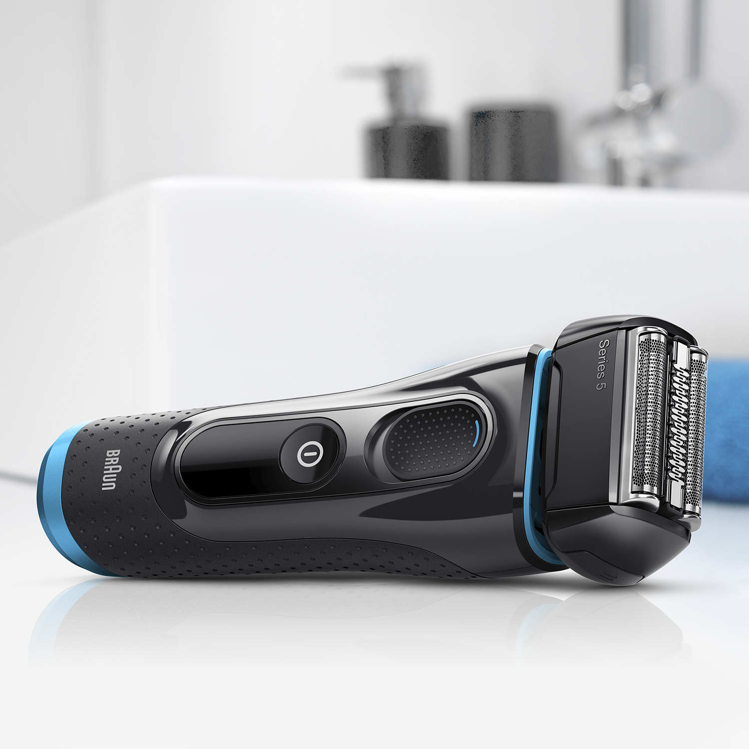 Black and blue Braun Series 5 electric shaver on a white surface.