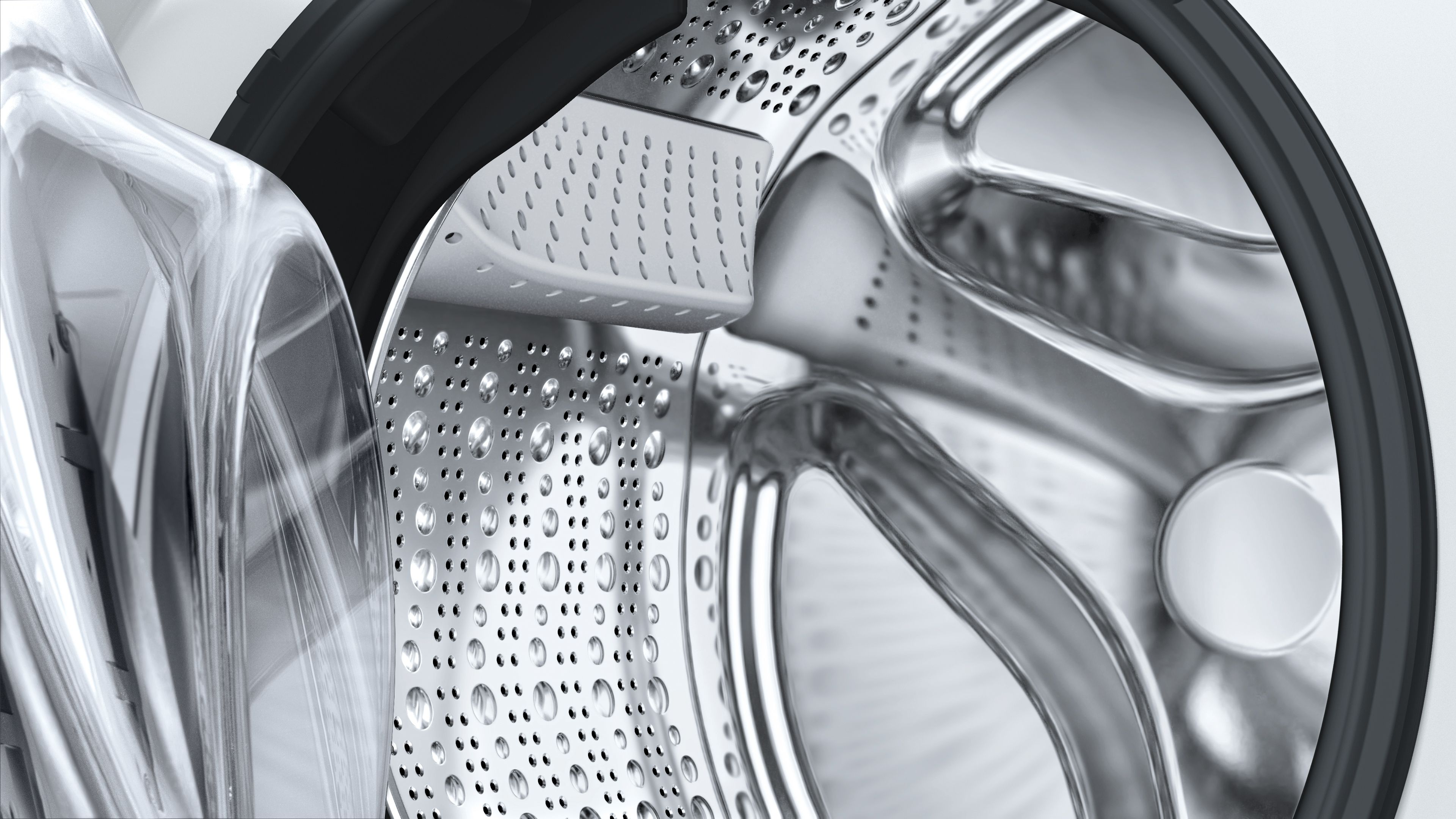 Bir çamaşır makinesi tamburunun içinde, şeffaf plastik kapılı paslanmaz çelik.