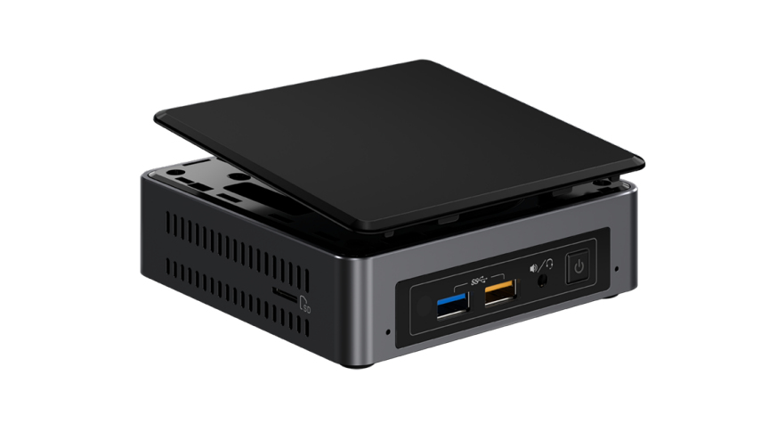 Pequeña computadora negra con tapa extraíble, mostrando puertos y ranura para tarjeta SD.