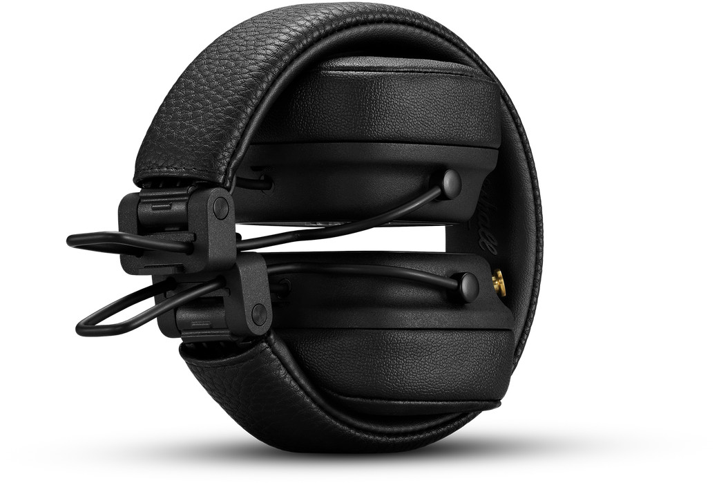 Black, folded headphones, with a gold-colored jack.