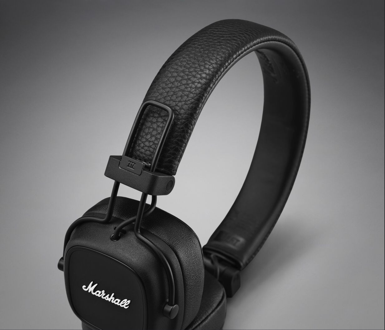 Black Marshall headphones, angled, showing earcups and headband.