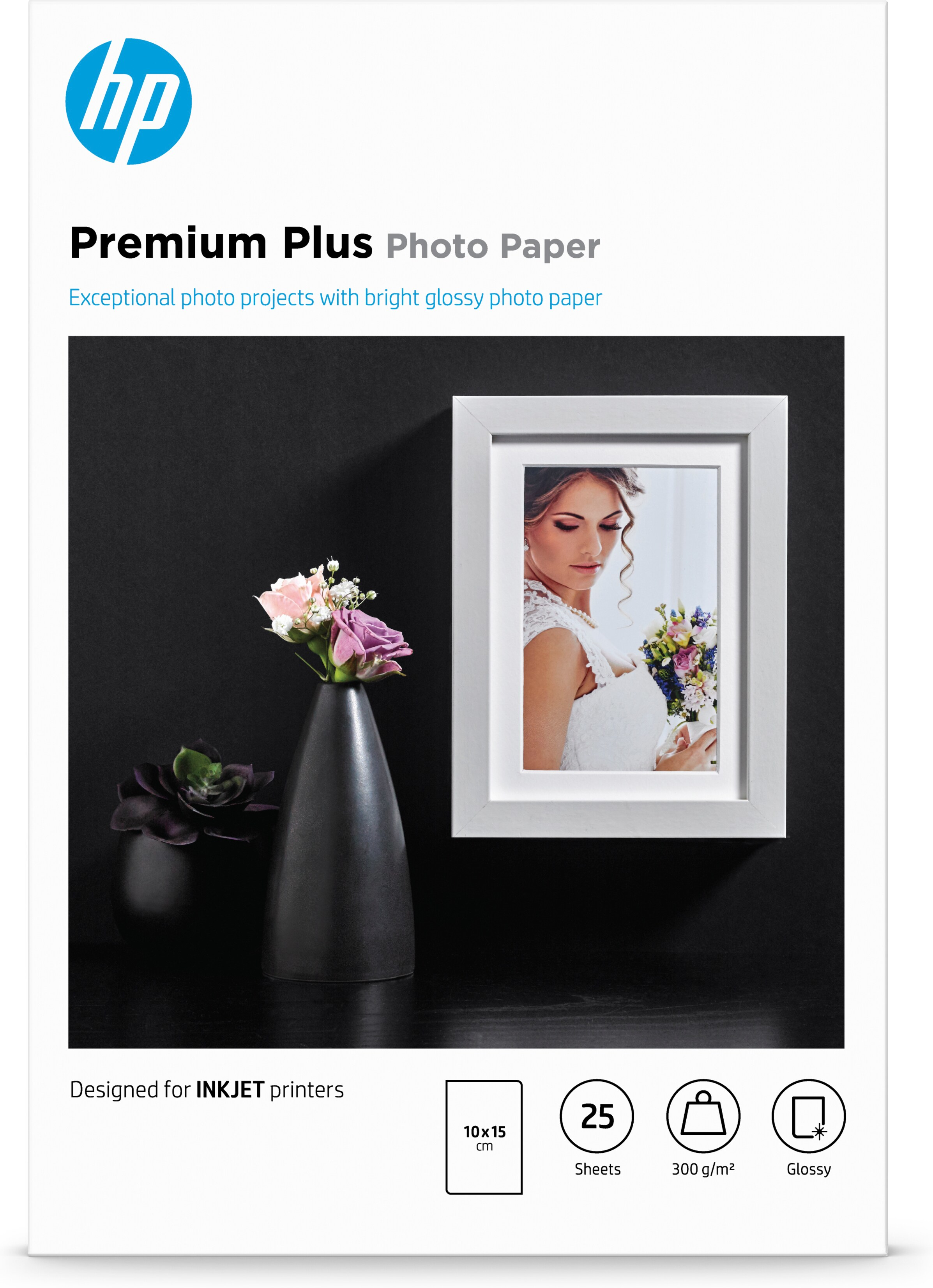 Fotopapierbox mit Bild und Vase mit Blumen auf schwarzem Untergrund.