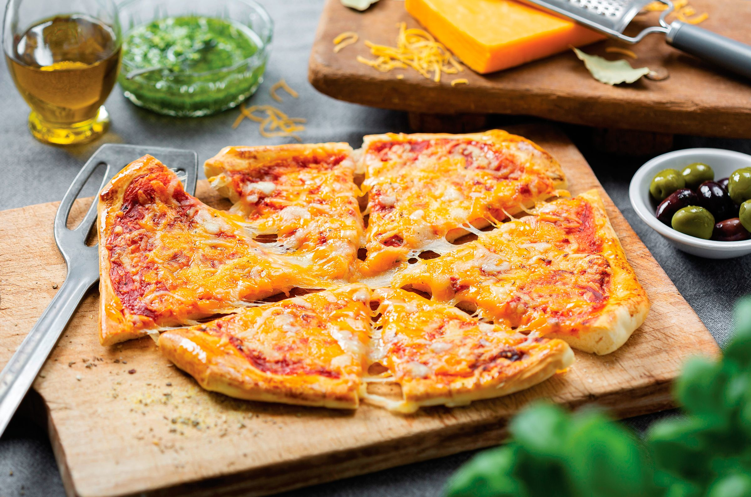 A close-up shot of a pizza with cheese and toppings.