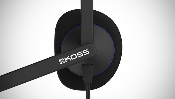 Close-up of a black headset with a microphone. The KOSS logo is visible.