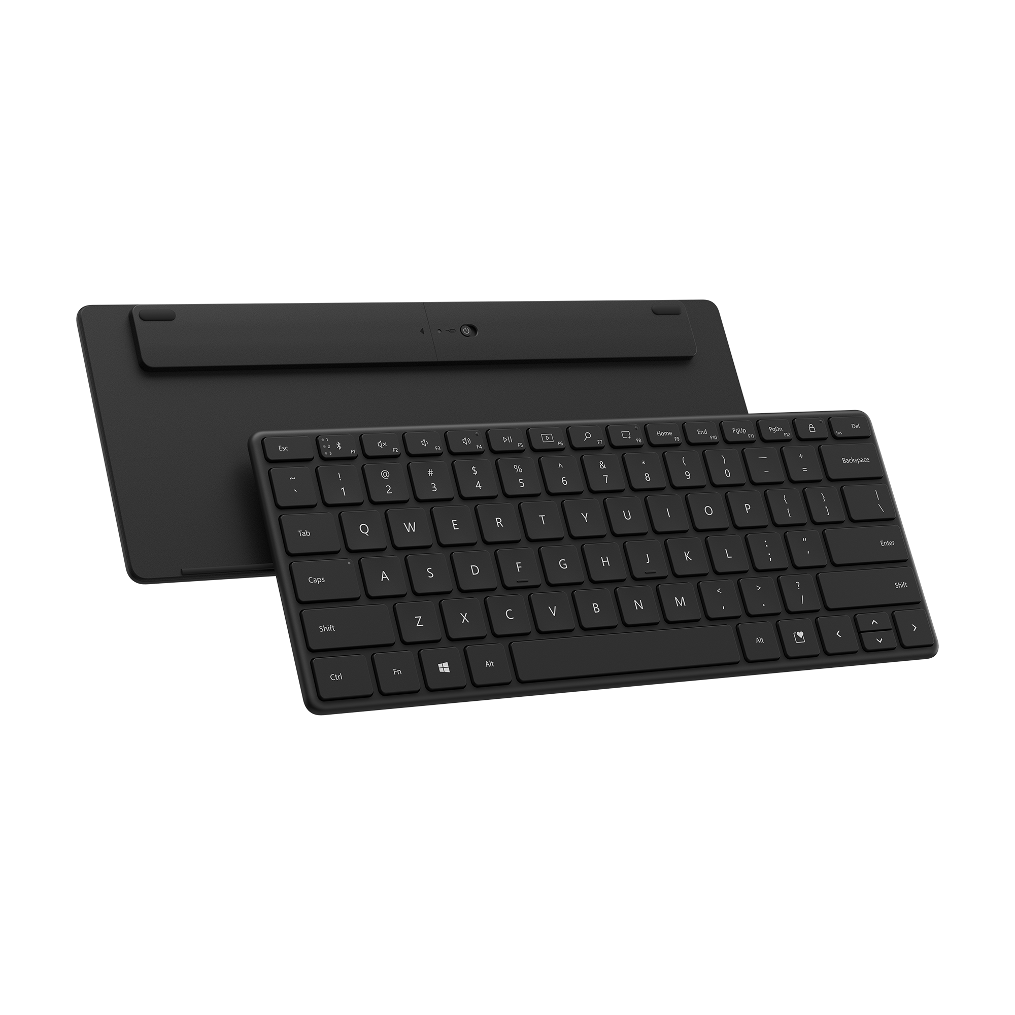 Arka planda bir tablet bulunan siyah bir klavye. Her ikisi de siyah bir yüzeyde.