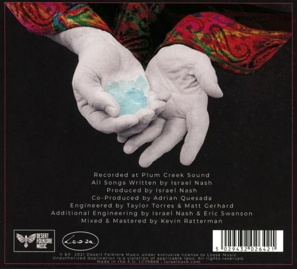 Albumcover. Hände halten blauen Kristall. Text oben und unten.