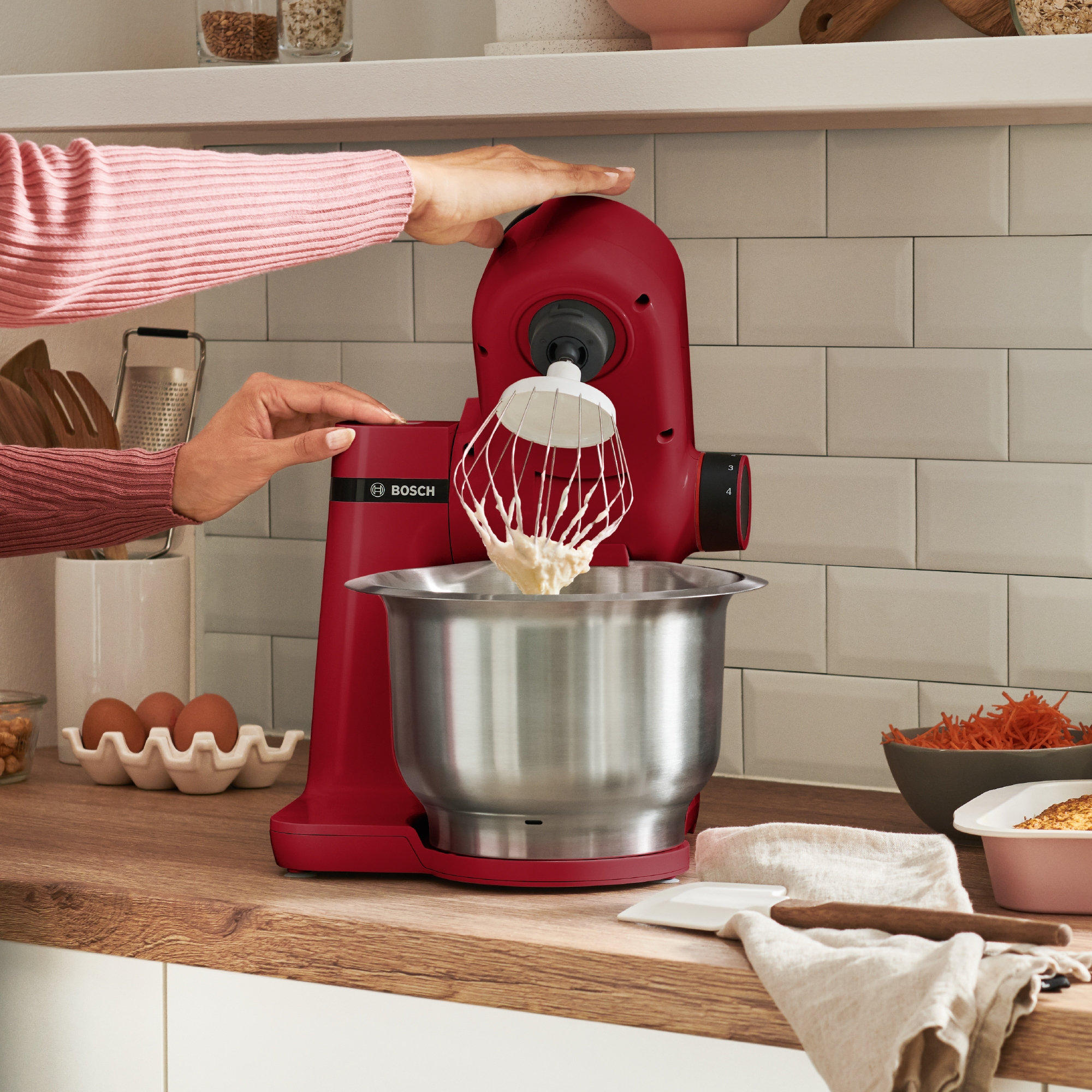 Robot de cocina Bosch rojo con bol de acero inoxidable, accesorio de varillas.