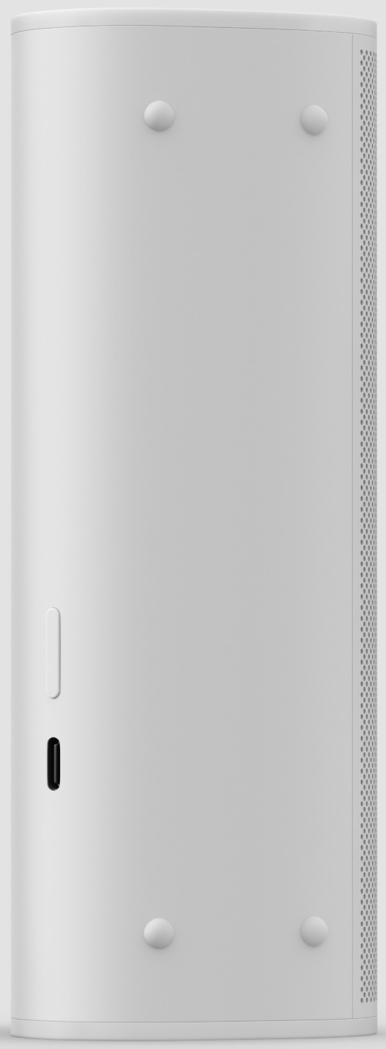 Un haut-parleur cylindrique blanc uni avec une petite encoche rectangulaire et quatre pieds ovales.