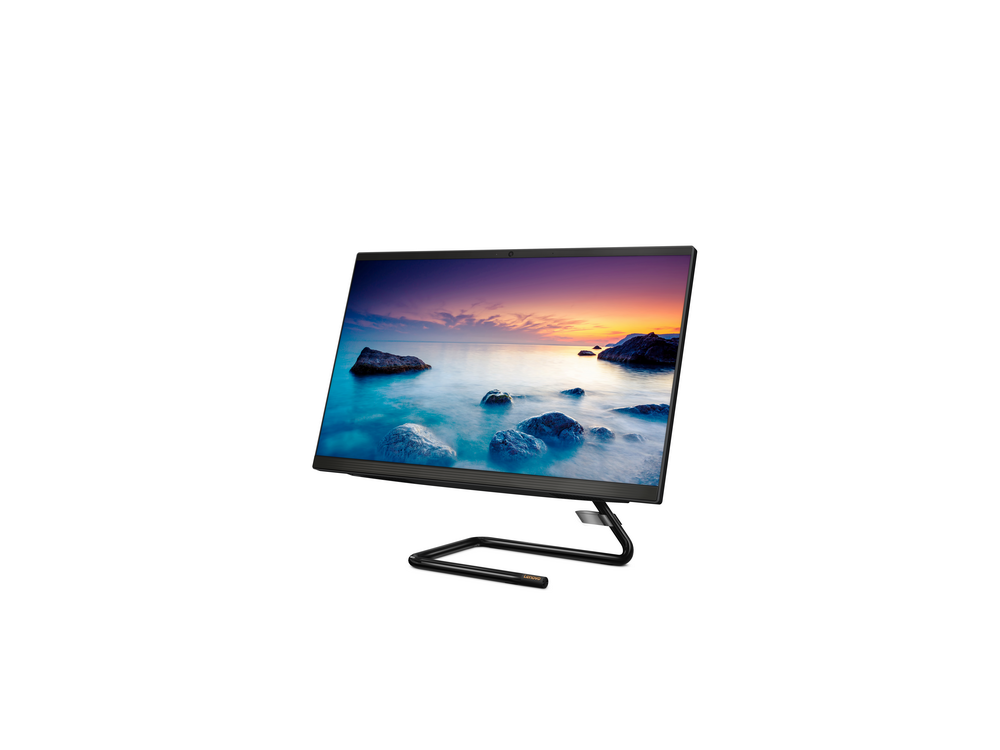 Monitor de computadora con soporte único. Pantalla muestra puesta de sol sobre el mar.