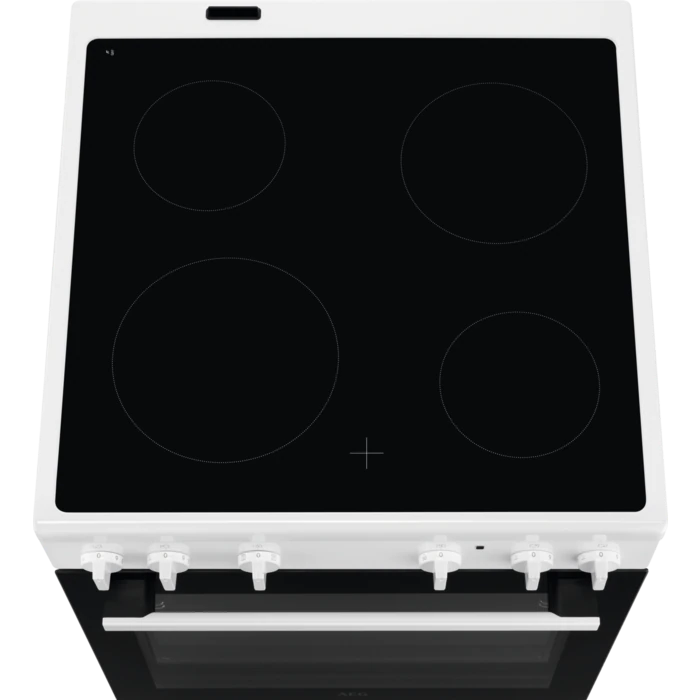White electric stove with four black burners. It's viewed from above, with white knobs below.
